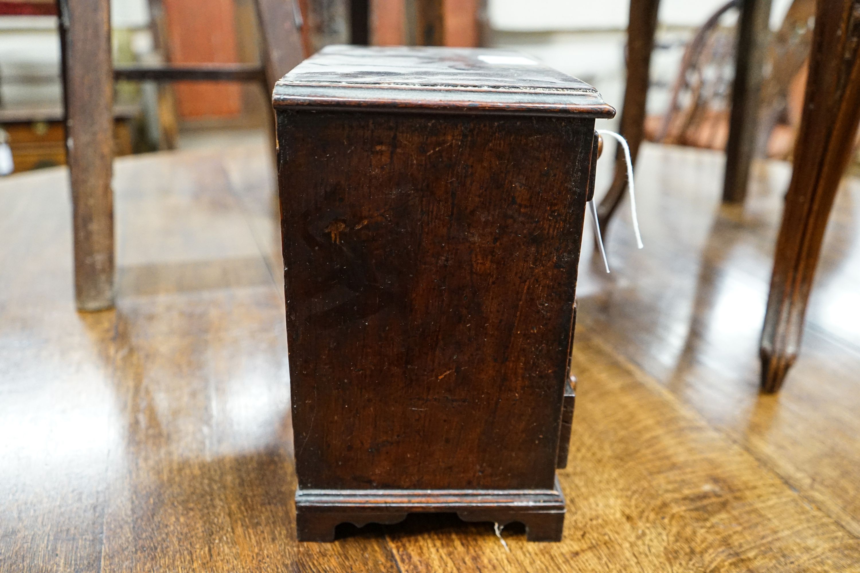 An antique mahogany miniature chest of drawers, width 27cm, depth 16cm, height 27cm